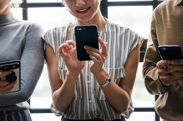 Group of diverse people using smartphones