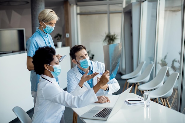 Group of doctors cooperating while examining Xray of a patient at the hopital