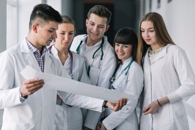 Group of doctors reading cardiogram