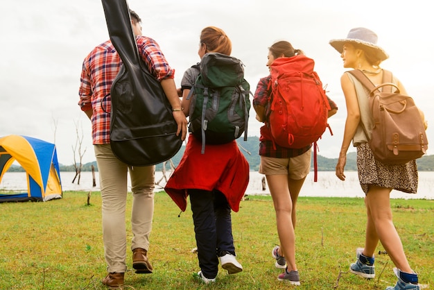 Group of Family Traveler Walking to Outdoor Camping Near the Lake for Hiking in Weekend Summer - Holiday Travel and Recreation Concept