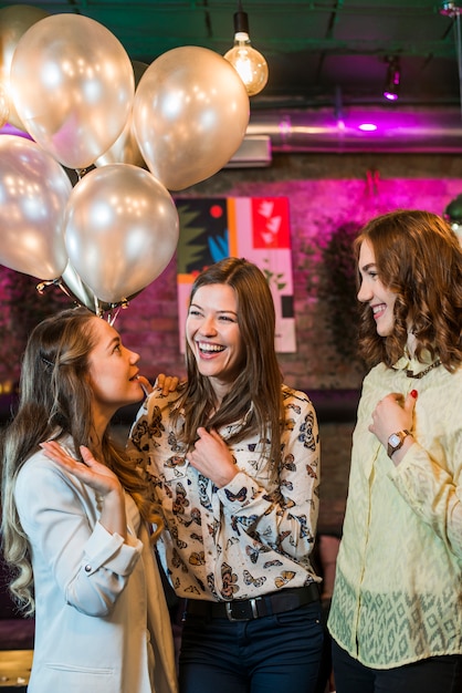 Group of female friends having fun in party at night club