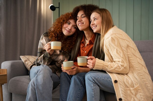 group of female friends watching sports at home and having a drink