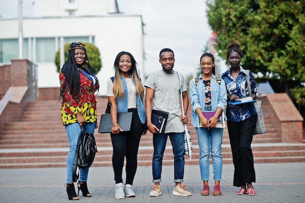 5명의 아프리카 대학생 그룹이 대학 마당에서 캠퍼스에서 함께 시간을 보내며 교육 테마를 공부하는 흑인 아프리카 친구들
