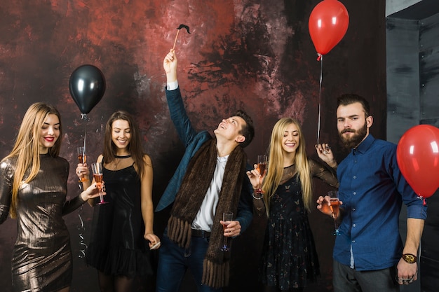 Group of five friends having a 2018 party