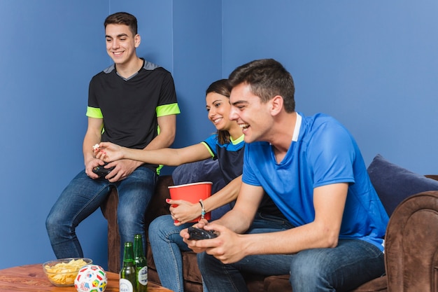 Group of football fans in living room