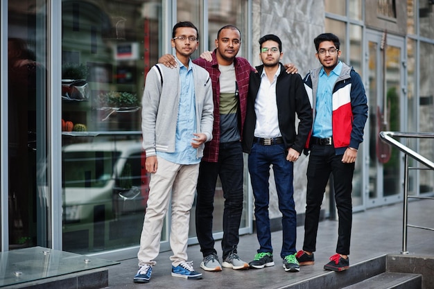 Group of four indian teen male students Classmates spend time together