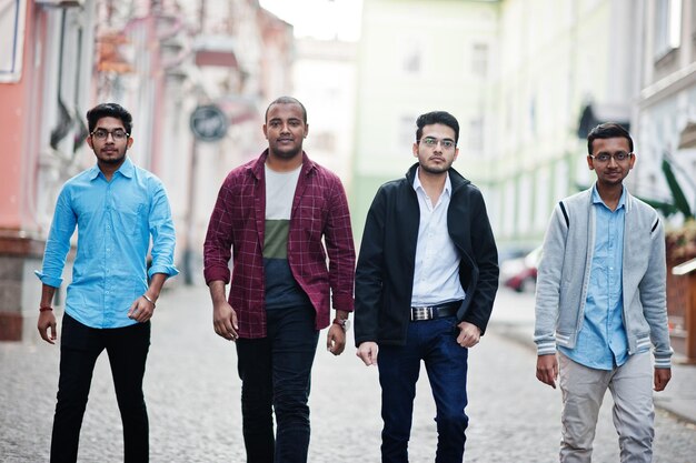 Group of four indian teen male students Classmates spend time together