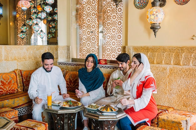Free Photo group of four muslim friends in restaurant