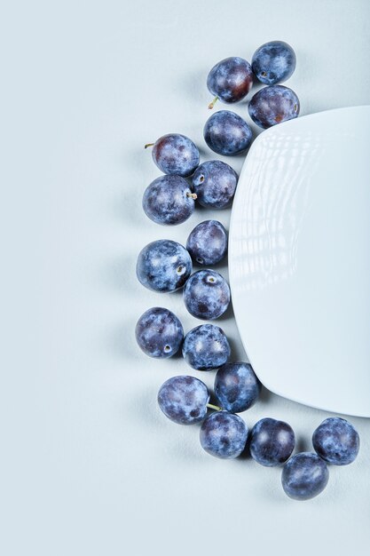 Group of fresh plums on a blue background. High quality photo