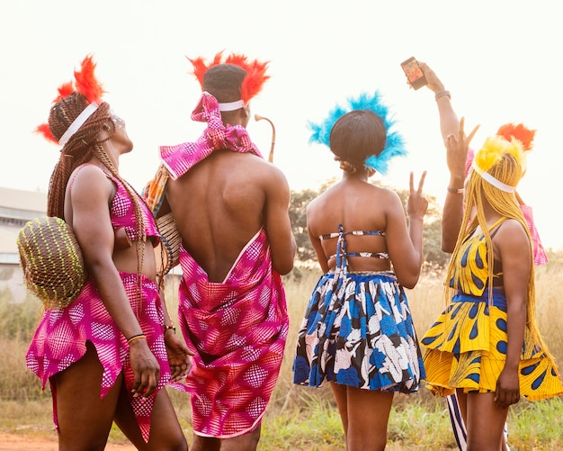 Group of friends at african carnival wearing costumes