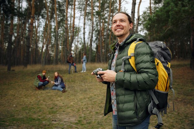 Group of friends on a camping or hiking trip in autumn day