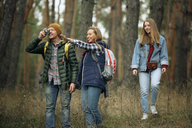 Group of friends on a camping or hiking trip in autumn day