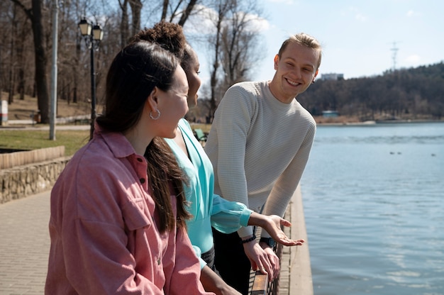 Group of friends celebrating the lifting of face mask restrictions outdoors