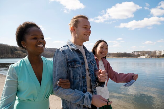 Group of friends celebrating the lifting of face mask restrictions outdoors