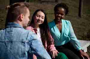 Free photo group of friends celebrating the lifting of face mask restrictions outdoors