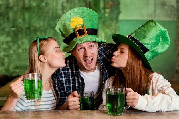 group of friends celebrating st. patrick's day together at the bar