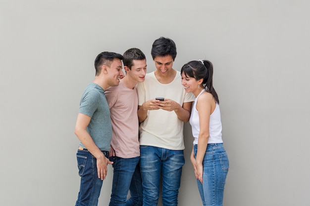 Group of friends checking a mobile phone
