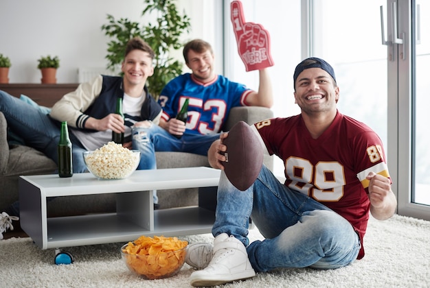 Group of friends cheering at home