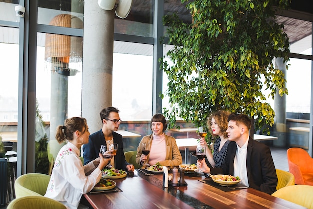 Group of friends eating in restaurant