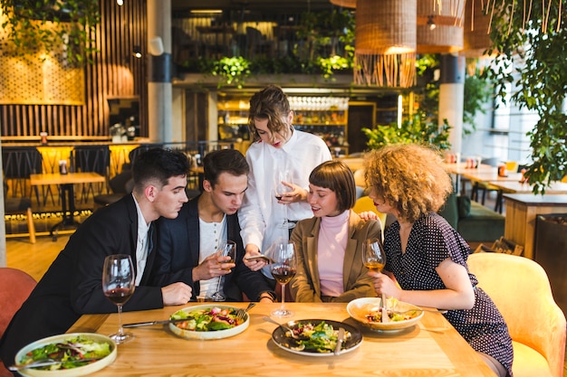 Group of friends eating in restaurant