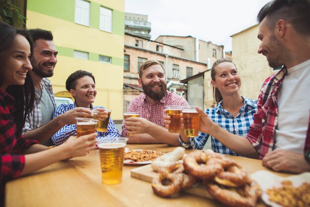 group of friends enjoying drink at outdoor bar