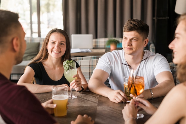 Group of friends enjoying drinks at restaurant