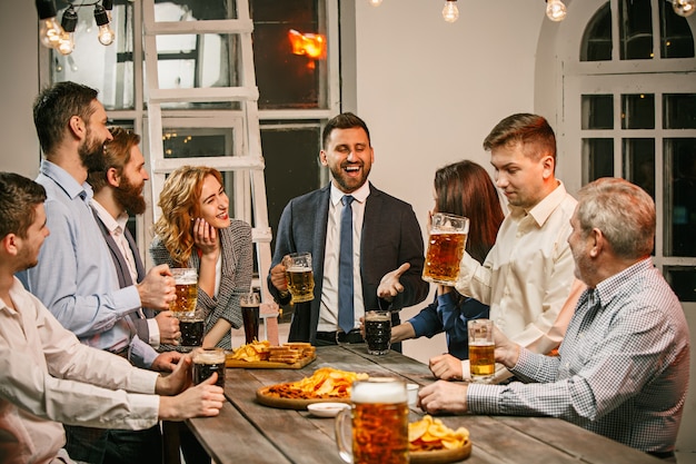 Group of friends enjoying evening drinks with beer