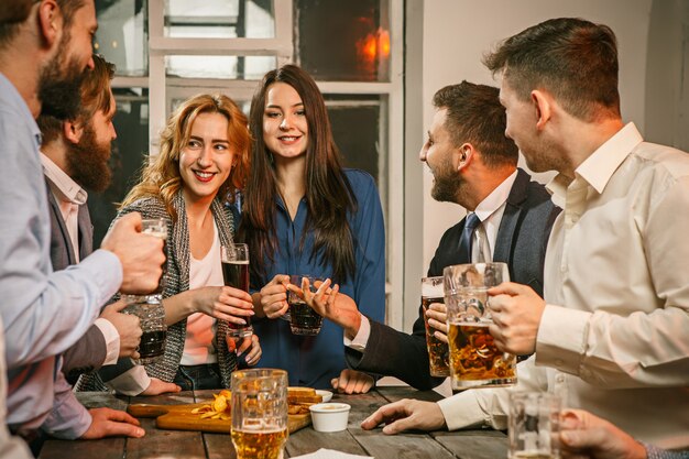 Group of friends enjoying evening drinks with beer