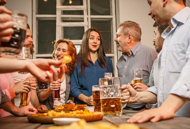 Group of friends enjoying evening drinks with beer