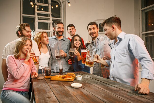 Group of friends enjoying evening drinks with beer