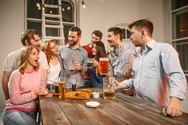 Group of friends enjoying evening drinks with beer