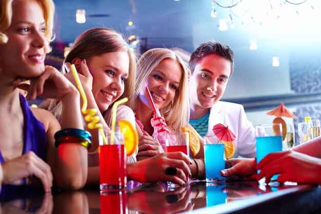 Group of friends having drinks at the bar