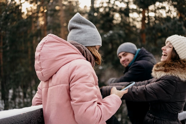 Group of friends having fun outdoors in winter