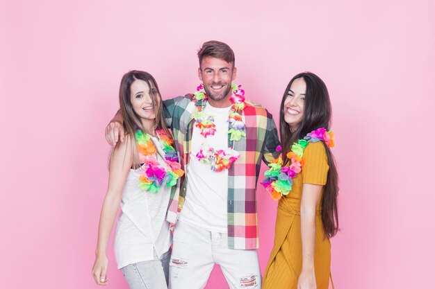 Group of friends having fun on pink background