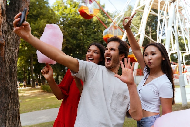 Group of friends having fun together at a ferris wheel