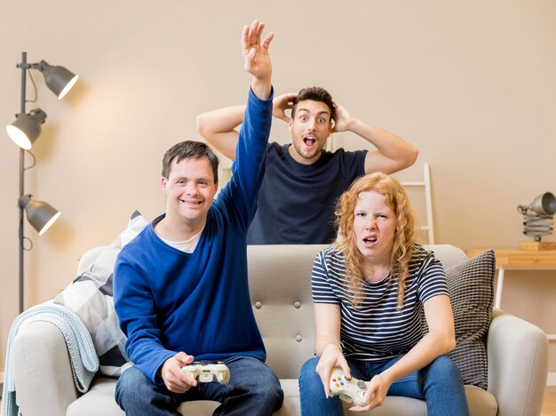 Group of friends having fun while playing video games