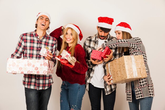 Group of friends holding gift boxes