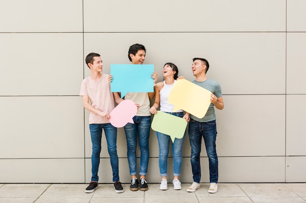 Group of friends holding speech bubbles