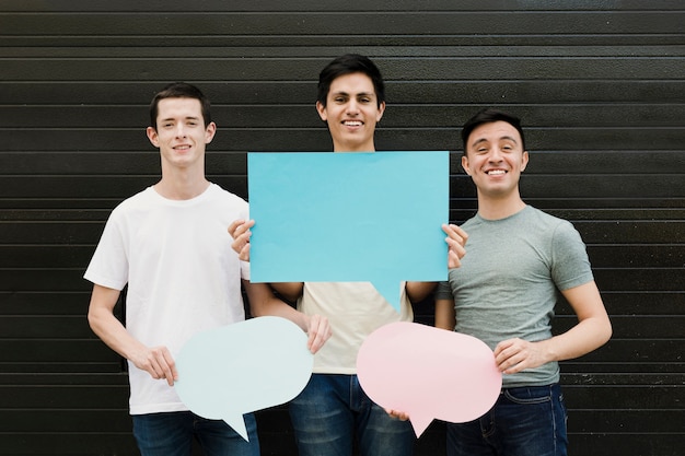 Group of friends holding speech bubbles