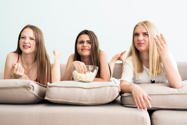 Free photo group of friends looking confused at a movie