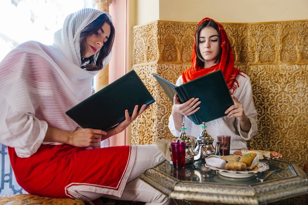 Group of friends looking at menu in arab restaurant