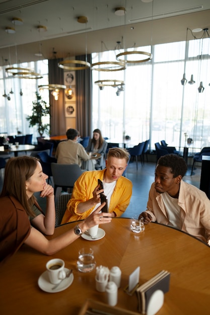 Free photo group of friends looking at the menu together at restaurant