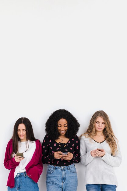 Group of friends looking on a phone with copy space