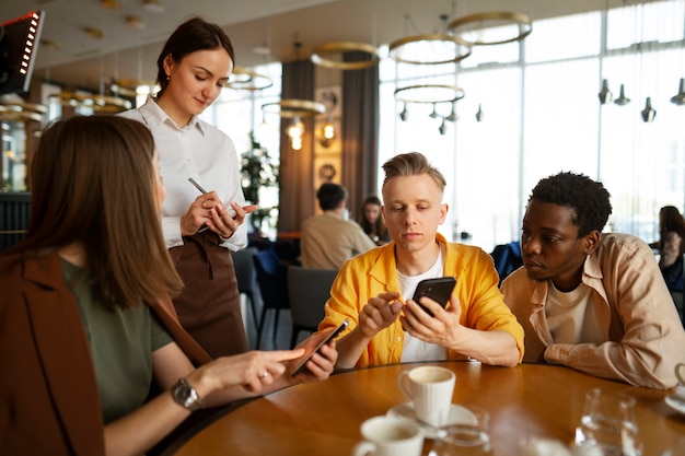 Free photo group of friends ordering at restaurant