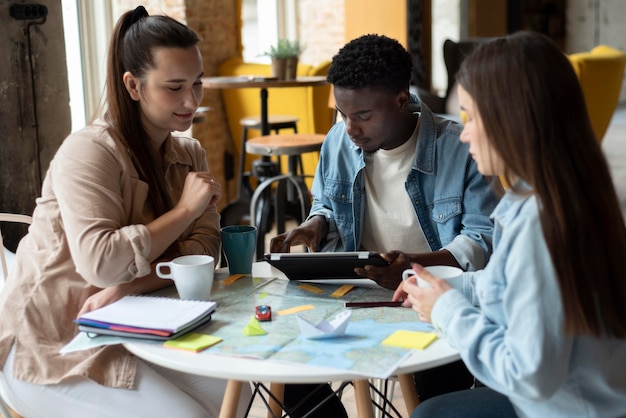 Group of friends planning a trip in a cafe