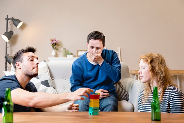 Group of friends playing games and having beer