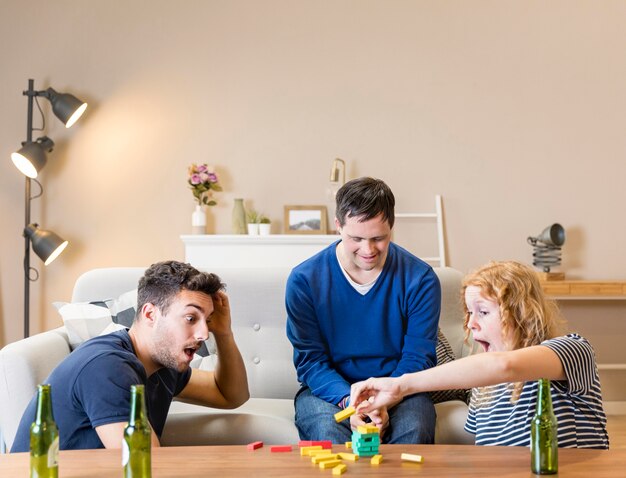 Group of friends playing games at home