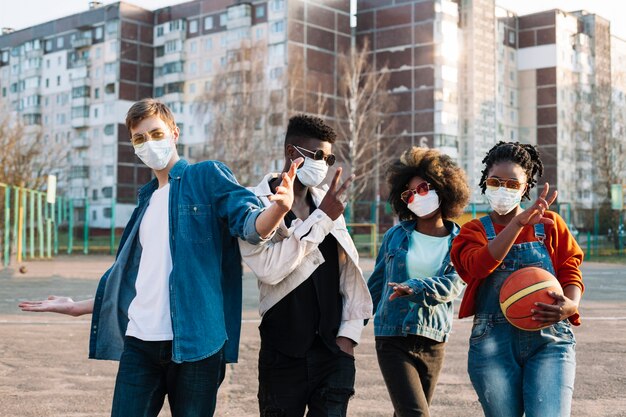 Group of friends posing with surgical masks