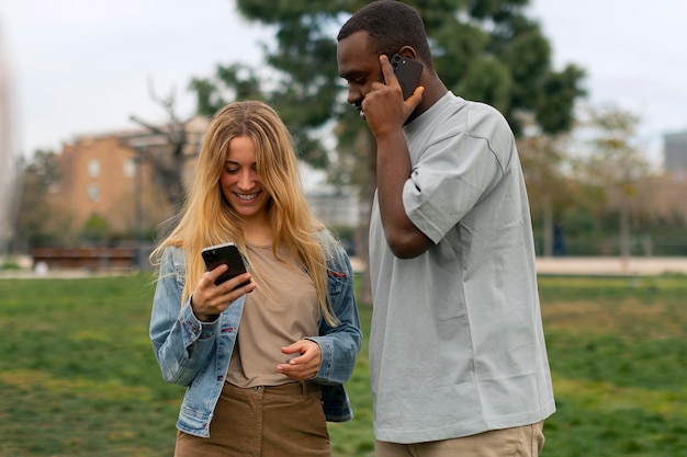 Free photo group of friends reading cell phone messages