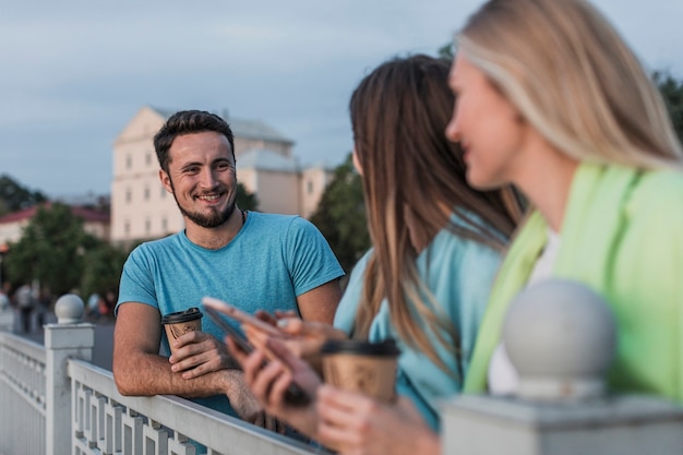 Group of friends resting on a railing